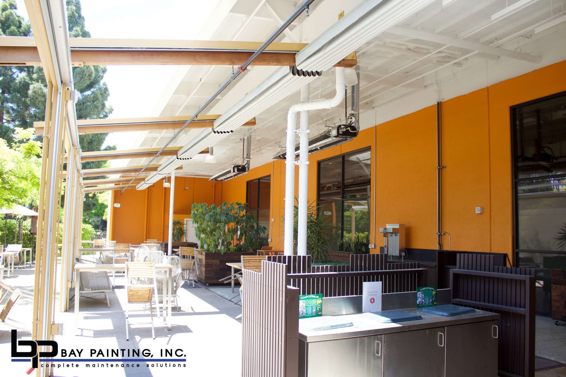 Painted exterior trim and overhang above an office courtyard