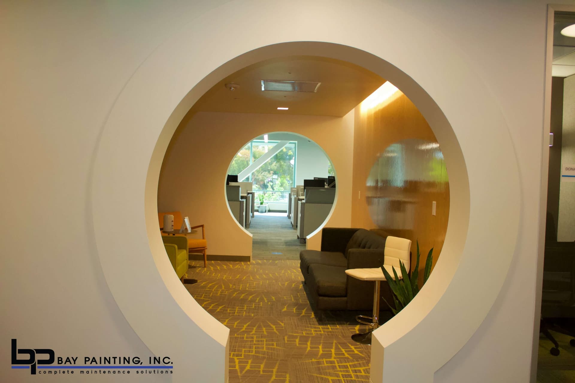 Painted circular architectural doorway connecting office common areas