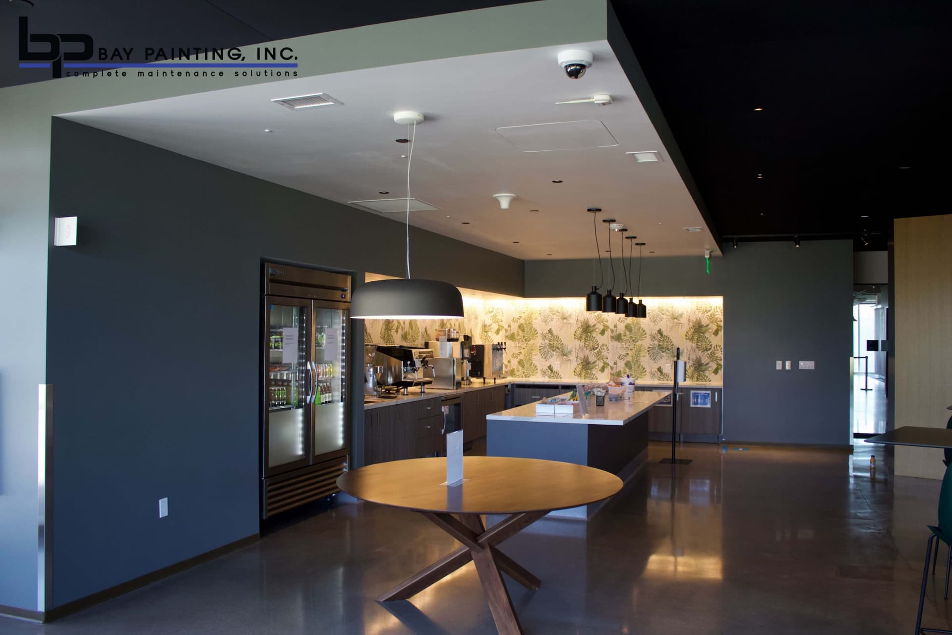 Painted kitchen and lounge area with accent wall finishes in a commercial office