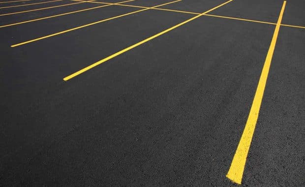 Freshly painted yellow parking lot line striping
