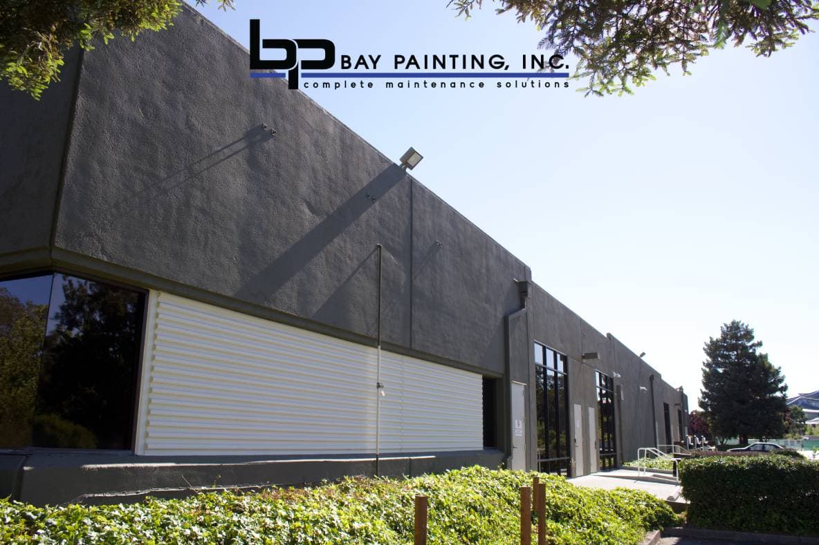 Repainted warehouse exterior with cream roll-up door, San Jose, CA